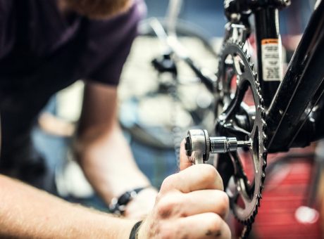 A bike technician makes adjustments to chain and derailleur on a bicycle in a repair shop, getting it ready for the customer to pick up.  He focuses intently on his work. A fun job and hobby for bicycle enthusiasts. Horizontal with copy space. 

[url=http://www.istockphoto.com/file_search.php?action=file&lightboxID=8849527][IMG]http://i186.photobucket.com/albums/x196/hybridsoul2/Bikeban.jpg[/IMG][/url]